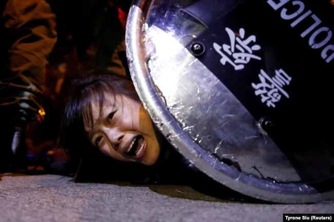 An anti-extradition bill protester is detained by riot police during a protest outside Mong Kok police station, in Hong Kong on September 2, 2019.