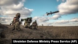 In this image released by Ukrainian Defense Ministry Press Service, Ukrainian soldiers use a launcher with U.S. Javelin missiles during military exercises in Donetsk region, December 23, 2021.
