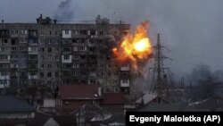 An apartment building explodes after a Russian army tank fires in Mariupol, March 11, 2022. (Evgeniy Maloletka/AP)