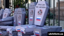 UKRAINE – Symbolic cardboard coffins near the Russian embassy in Ukraine with the inscriptions «Груз 200 ЧВК «Вагнера» ("Cargo 200. PMK Wagner") during a rally against Russian aggression in the Donbass. Kyiv, June 2, 2018