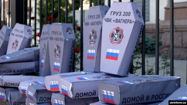 UKRAINE – Symbolic cardboard coffins near the Russian embassy in Ukraine with the inscriptions «Груз 200 ЧВК «Вагнера» ("Cargo 200. PMK Wagner") during a rally against Russian aggression in the Donbass. Kyiv, June 2, 2018