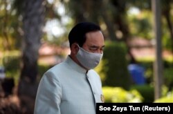 Thailand's Prime Minister Prayut Chan-o-cha wears a protective mask due to the COVID-19 outbreak, as he comes out from a meeting at Government House in Bangkok on March 24, 2020.