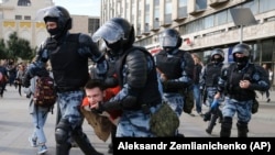 RUSSIA -- Police officers detain a protestor, during an unsanctioned rally in the center of Moscow, August 3, 2019