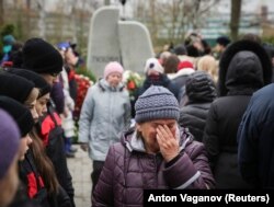 RUSSIA -- A woman cries at an opening ceremony of a monument commemorating victims of the crash of Metrojet Airbus A321 in Egypt's Sinai peninsula in 2015, in St. Petersburg, Russia October 28, 2017