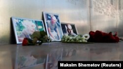 RUSSIA -- Photographs of journalists, (R-L) Orhan Dzhemal, Kirill Radchenko and Aleksandr Rastorguyev, who were recently killed in the Central African Republic by unidentified assailants, are on display outside the Central House of Journalists in Moscow.