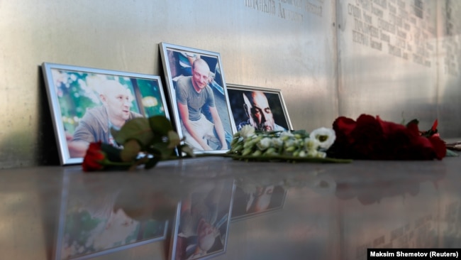 RUSSIA -- Photographs of journalists, (R-L) Orhan Dzhemal, Kirill Radchenko and Aleksandr Rastorguyev, who were recently killed in Central African Republic by unidentified assailants, are on display outside the Central House of Journalists in Moscow.