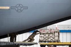 U.S soldiers unload medical aid from the United States, including ventilators as a donation to help Russia tackle the coronavirus outbreak, after a U.S. air force plane landed at Vnukovo International Airport in Moscow, June 4, 2020.