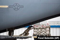 U.S soldiers unload medical aid from the United States, including ventilators as a donation to help Russia tackle the coronavirus outbreak, after a U.S. air force plane landed at Vnukovo International Airport in Moscow, June 4, 2020.