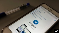 The messaging app Telegram is displayed on a smartphone