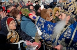 Orthodox archbishop Teodosie blesses worshipers during an Epiphany religious service in Constanta on Monday, January 6, 2020.
