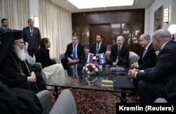 ISRAEL -- Russian President Vladimir Putin, Israeli Prime Minister Benjamin Netanyahu, Yaffa Issachar, mother of Naama Issachar who is jailed in Russia on drug charges, and officials attend a meeting in Jerusalem, January 23, 2020