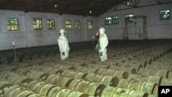 RUSSIA -- Two Russian soldiers make a routine check of metal containers with toxic agents at a chemical weapons storage site in the town of Gorny, 124 miles (200 kms) south of the Volga River city of Saratov, May 20, 2000