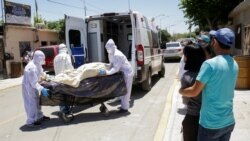MEXICO – Paramedics transport the body of a man who died from COVID-19 in Ciudad Juarez, on May 26, 2020.