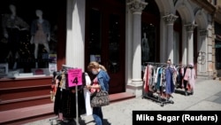 FILE PHOTO: Shoppers browse racks of clothes at a newly re-opened retail store along Broadway in lower Manhattan on the first day of the phase two re-opening of businesses following the outbreak of COVID-19 in New York City, New York, U.S., June 22, 2020. 