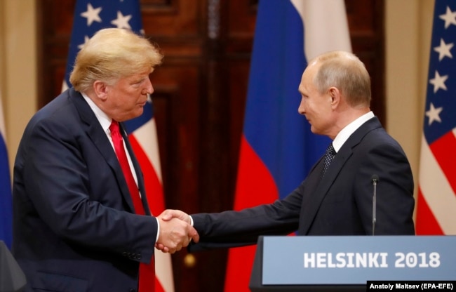 FINLAND -- U.S. President Donald Trump (L) and Russian President Vladimir Putin shake hands during a joint press conference following their summit talks at the Presidential Palace in Helsinki, July, 16, 2018
