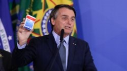 President Jair Bolsonaro speaks at the inauguration ceremony of Eduardo Pazuello as health minister while holding a box of hydroxychloroquine, on September 16, 2020.