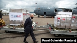 RUSSIA -- U.S. Ambassador to Russia, John Sullivan, walks past the batch of medical aid from the United States, including ventilators as a donation to help the country tackle the coronavirus outbreak, at Vnukovo International Airport outside Moscow, June 2020.