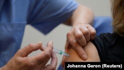 A woman receives a dose of the Moderna COVID-19 vaccine at a vaccination center in Brussels, as part of the coronavirus disease (COVID-19) vaccination campaign, in Belgium, February 2, 2021.