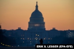 U.S. -- A man walks on the National Mall in front of the U.S. Capitol building at dawn in Washington, DC, U.S., December 27, 2018