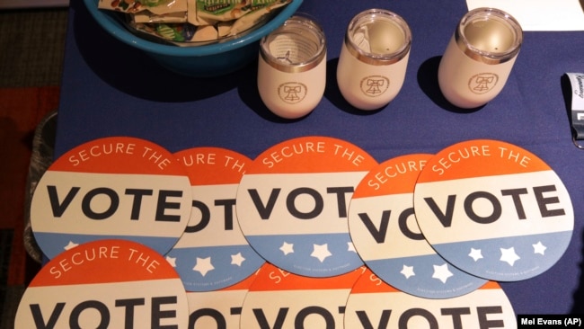 U.S. -- Computer mouse pads with Secure the Vote logo on them are seen on a vendor's table at a convention of state secretaries of state in Philadelphia, July 14, 2018