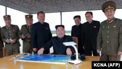 North Korean leader Kim Jong-Un watches the launch of a medium-range ballistic missile, August 29, 2017.