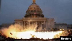 U.S. – An explosion caused by a police munition is seen while supporters of U.S. President Donald Trump gather in front of the U.S. Capitol Building in Washington, D.C., January 6, 2021.