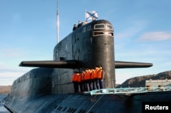 The crew of Russia’s nuclear-powered submarine Yekaterinburg line up as it returns to Gadjiyevo base in Murmansk region, September 26, 2006.
