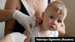 UKRAINE -- A child receives a vaccine injection at a kids clinic in Kyiv, Ukraine August 14, 2019. 