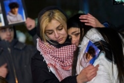 CANADA -- Mourners console each other during a vigil for the victims of Ukrainian Airlines flight 752 which crashed in Iran during a vigil at Mel Lastman Square in Toronto, Ontario on January 9, 2020.