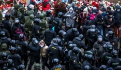 Law enforcement officers detain opposition supporters during a rally to protest against the Belarus presidential election results in Minsk, Belarus, on November 15, 2020.