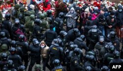 Law enforcement officers detain opposition supporters during a rally to protest against the Belarus presidential election results in Minsk, Belarus, on November 15, 2020.