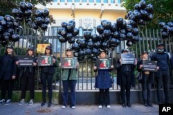 Members of Reporters Without Borders demonstrate outside the Russian Embassy in Paris on October 6, 2021, to pay tribute to Russian journalist Anna Politkovskaya, who was shot dead on October 7, 2006, in Moscow. (Michel Euler/AP)