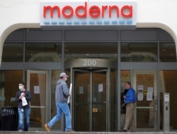 FILE PHOTO: A sign marks the headquarters of Moderna Therapeutics, which is developing a vaccine against COVID-19, in Cambridge, Massachusetts, U.S., May 18, 2020.