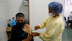 A health worker administers a dose of the Sputnik V vaccine at the Victorino Santaella Hospital in Los Teques, on April 9, 2021.