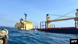 The Rubymar cargo ship sinking off the coast of Yemen on February 27, 2024. The Belize-flagged, British-registered and Lebanese-operated cargo ship was damaged in a missile strike on February 25 claimed by the Iran-backed Huthi rebels. (AFP)