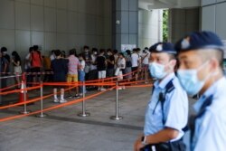 Supporters of Tong Ying-kit, the first person charged under the new National Security Law, line up to attend the hearing at the High Court on July 30, 2021.