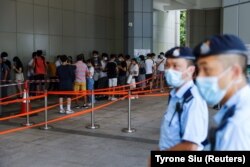 Supporters of Tong Ying-kit, the first person charged under the new National Security Law, line up to attend the hearing at the High Court on July 30, 2021.