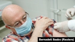 FILE PHOTO: A man receives a dose of the Sinopharm coronavirus disease (COVID-19) vaccine, in Budapest, Hungary February 26, 2021. 