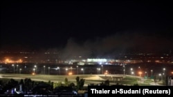 Smoke rises over Erbil, Iraq, after reports of mortar shells landing near Erbil airport, February 15, 2021.