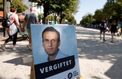 GERMANY -- A poster with a picture of Russian opposition leader Aleksei Navalny captioned "poisoned" is seen outside the Russian embassy on Unter den Linden in Berlin, Sept. 23, 2020.