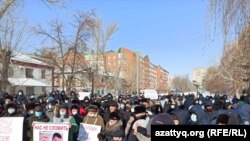 At a rally in Uralsk, a protester holds a poster saying, "Nazarbayev is a dictator" on February 28, 2021.