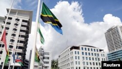 FILE PHOTO: Various flags fly at half mast following the death of Tanzania's President John Magufuli in Dar es Salaam, Tanzania March 18, 2021. REUTERS/Emmanuel Herman/File Photo