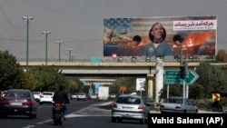 IRAN -- Vehicles drive on a highway under an anti-U.S. billboard with a portrait of former President Barack Obama, in Tehran, November 3, 2020.