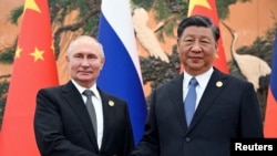FILE PHOTO: Russian President Vladimir Putin shakes hands with Chinese President Xi Jinping during a meeting at the Belt and Road Forum in Beijing, China, October 18, 2023.