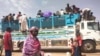 People board a truck as they leave Khartoum, Sudan, Monday, June 19, 2023. (AP Photo)
