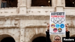 A demonstrator holds a placard as activists demonstrate outside the Colosseum, calling on G20 leaders to boycott the Beijing 2022 Winter Olympics due to China's treatment of Tibet, Uyghur Muslims and Hong Kong. (Yara Nardi/Reuters)