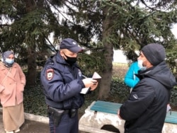 Russian police officers copying the data of the Crimean Tatars who came to support the detainees during the searches, Sevastopol, February 9, 2022.