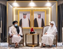 Qatar's Foreign Minister Mohammed bin Abdulrahman Al Thani (right) meets with Mullah Abdul Ghani Baradar, head of the Taliban's political bureau, in Doha on August 17, 2021. (Qatar/Reuters)
