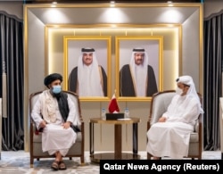 Qatar's Foreign Minister Mohammed bin Abdulrahman Al Thani (right) meets with Mullah Abdul Ghani Baradar, head of the Taliban's political bureau, in Doha on August 17, 2021. (Qatar/Reuters)