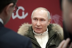 Russian President Vladimir Putin speaks with journalists as he attends a concert marking the seventh anniversary of Russia's annexation of Crimea at Luzhniki Stadium in Moscow on March 18, 2021.